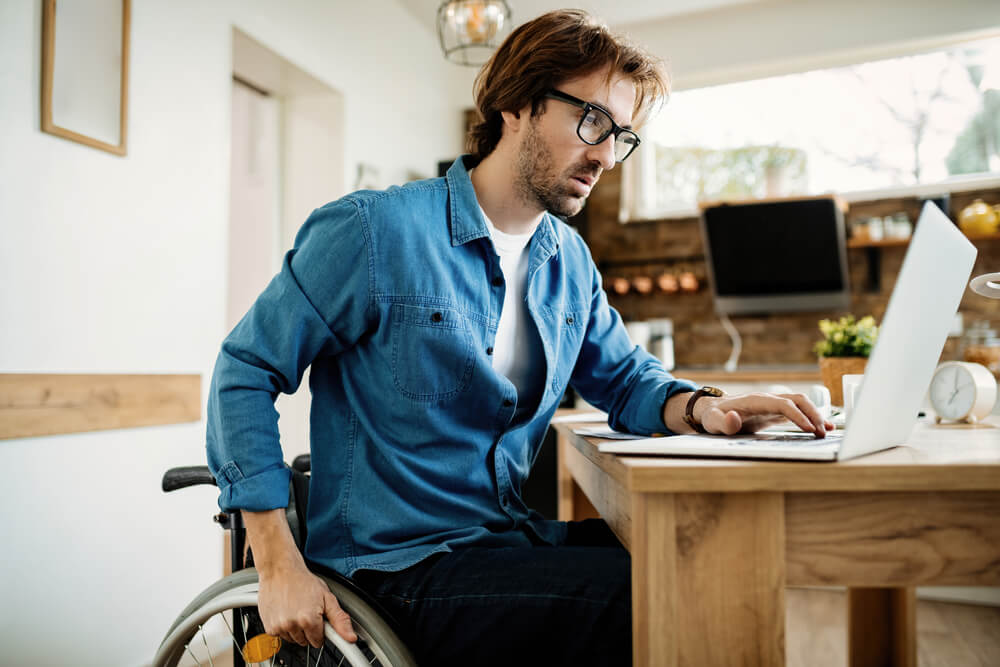 Real estate school student with a mobility disability studying for the Florida real estate exam